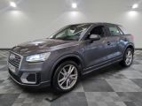 a grey audi suv parked in a garage