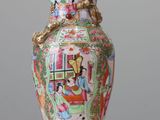 a vase that is sitting on a table with a lid