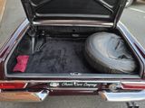 a car with a tire in the trunk of it