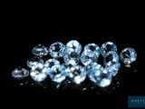 a close up of a bunch of blue diamonds on a black surface