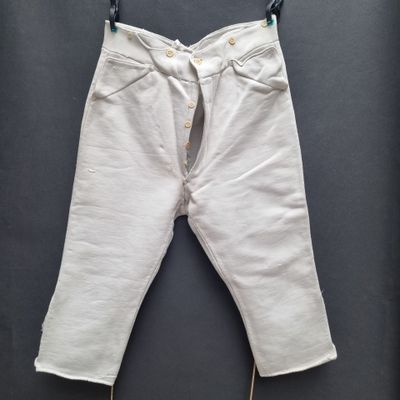 an image of a pair of white jeans hanging on a clothes line