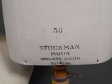 a close up of a mannequin on a stand with a label on it