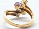 an image of a gold ring with a purple and green stone