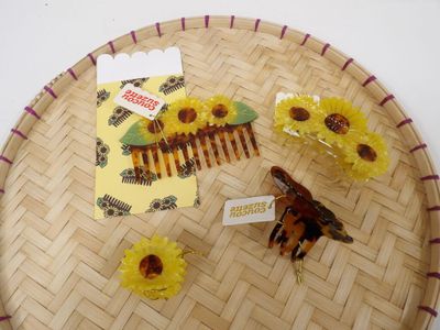 a tray with a comb and some flowers on it