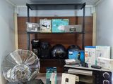 a microwave and a fan on a table in a room