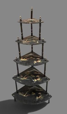 a three tiered shelf with a clock on top of it