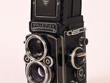 a black camera with a white background and a white background