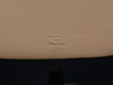 a close up of the back of a white leather chair