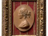 portrait of a woman in profile in a gold frame on a red background