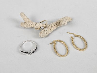 two pairs of earrings, a ring, and a piece of jewelry