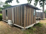 a picture of a small wooden cabin in the woods
