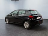 the back of a black car in a room with a white wall
