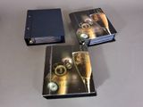 trois livres posés sur une table, avec un verre de vin devant eux