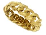 a close up of a gold bracelet on a white background