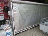 a display case in the middle of a store with a lot of items in it