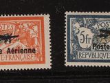 four different postage stamps are on a black surface