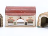 three small toy houses that are sitting on a table