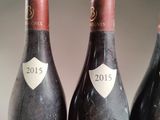 three bottles of wine sitting on top of a table next to each other