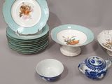 a lot of plates and bowls and spoons on the table