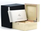 a box with a watch inside of it on a white surface