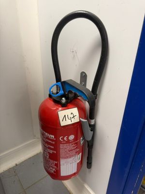 a fire extinguisor attached to the wall of a building
