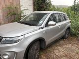 a silver suv parked in front of a building