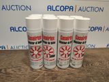 four cans of alcohol are sitting on a table in front of a sign