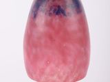 a pink and blue glass lamp hanging from a ceiling
