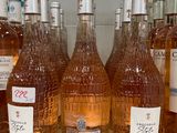 several bottles of wine are lined up on a shelf
