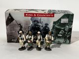 the figurines are in a box on a white surface