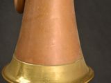 an old brass bell on a black background with a black background