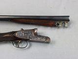 two old guns are sitting on a white surface with a gun in the foreground