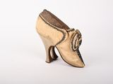 an old pair of women ' s shoes on a white surface