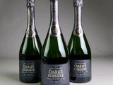 three bottles of champagne sitting next to each other on a table