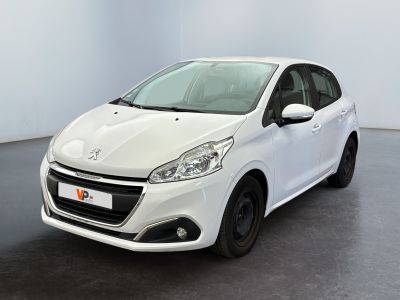 the small white car is parked in a room with a black floor
