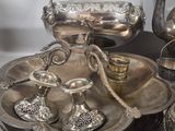 many silver objects on a table with a white background