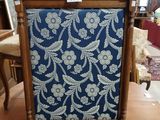 a wooden chair with a blue and white fabric on it