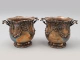 pair of silver vases with handles and handles on pedestals