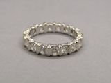 a close up of a diamond ring on a gray surface