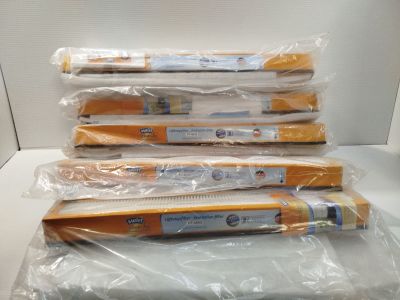 plusieurs brosses à dents emballées dans du plastique, empilées les unes sur les autres