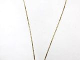 a gold necklace with a black and white picture on it
