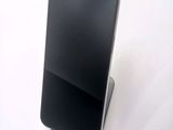a cell phone that is sitting on top of a stand