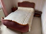a bed with a white quilt on it in a room