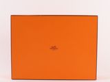an orange box with a logo on it sitting on a white surface