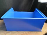 a blue plastic container sitting on top of a wooden table
