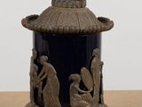 a blue vase sitting on top of a wooden table