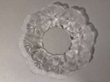 a picture of a white plastic wreath on a table