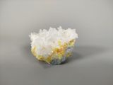 a close up of a small piece of yellow and white crystals