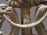 a statue of an elephant holding a ring in its trunk