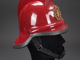 a close up of a red fireman ' s helmet on a mannequin head